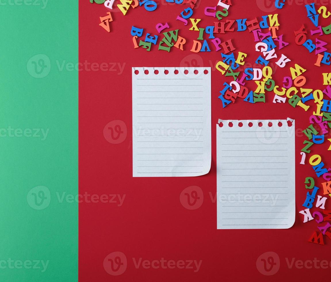 two empty sheets in a line on a red background photo
