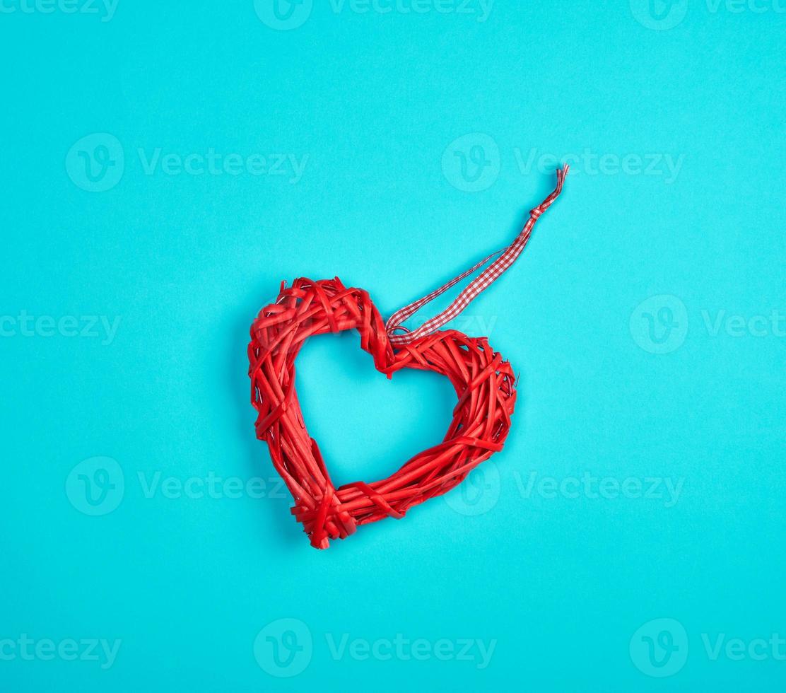 wicker red heart on a blue background, copy space photo