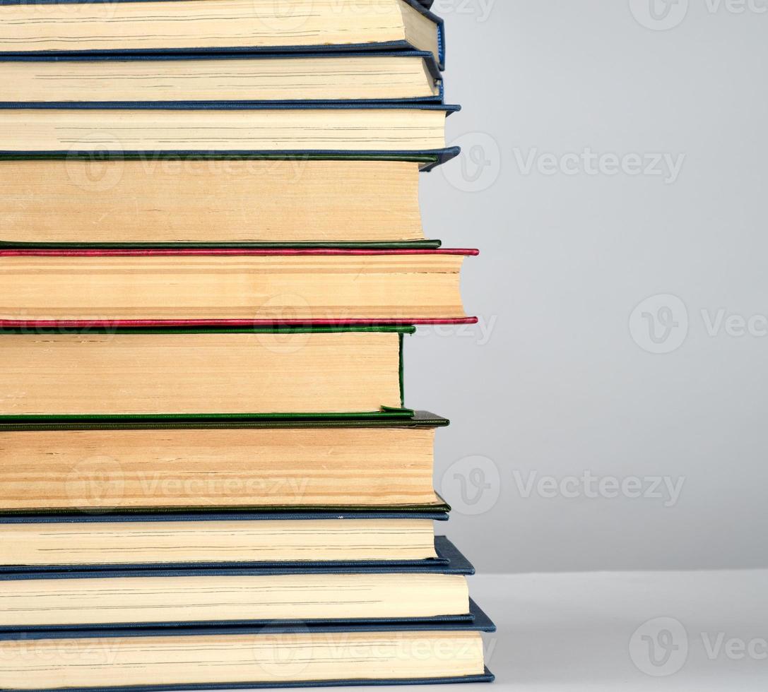 stack of different books on a gray background photo