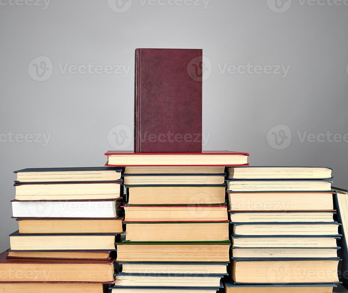 a stack of different books on a gray background photo