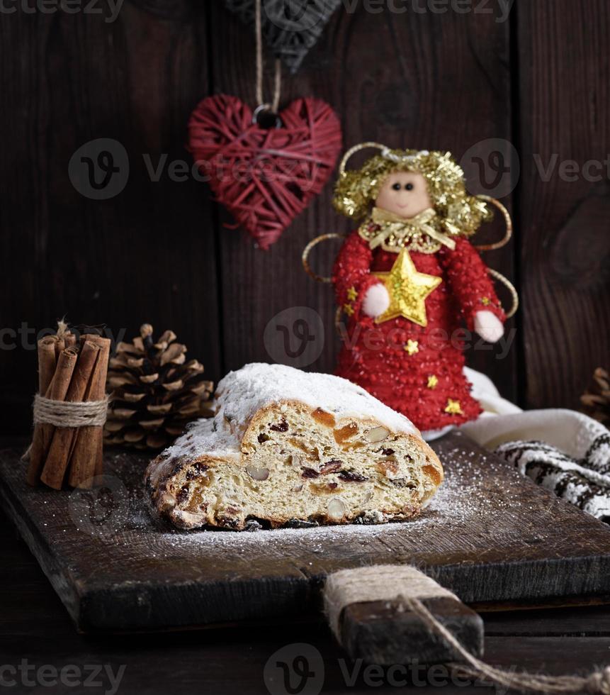 Christmas stollen cake with icing sugar, marzipan and raisins photo