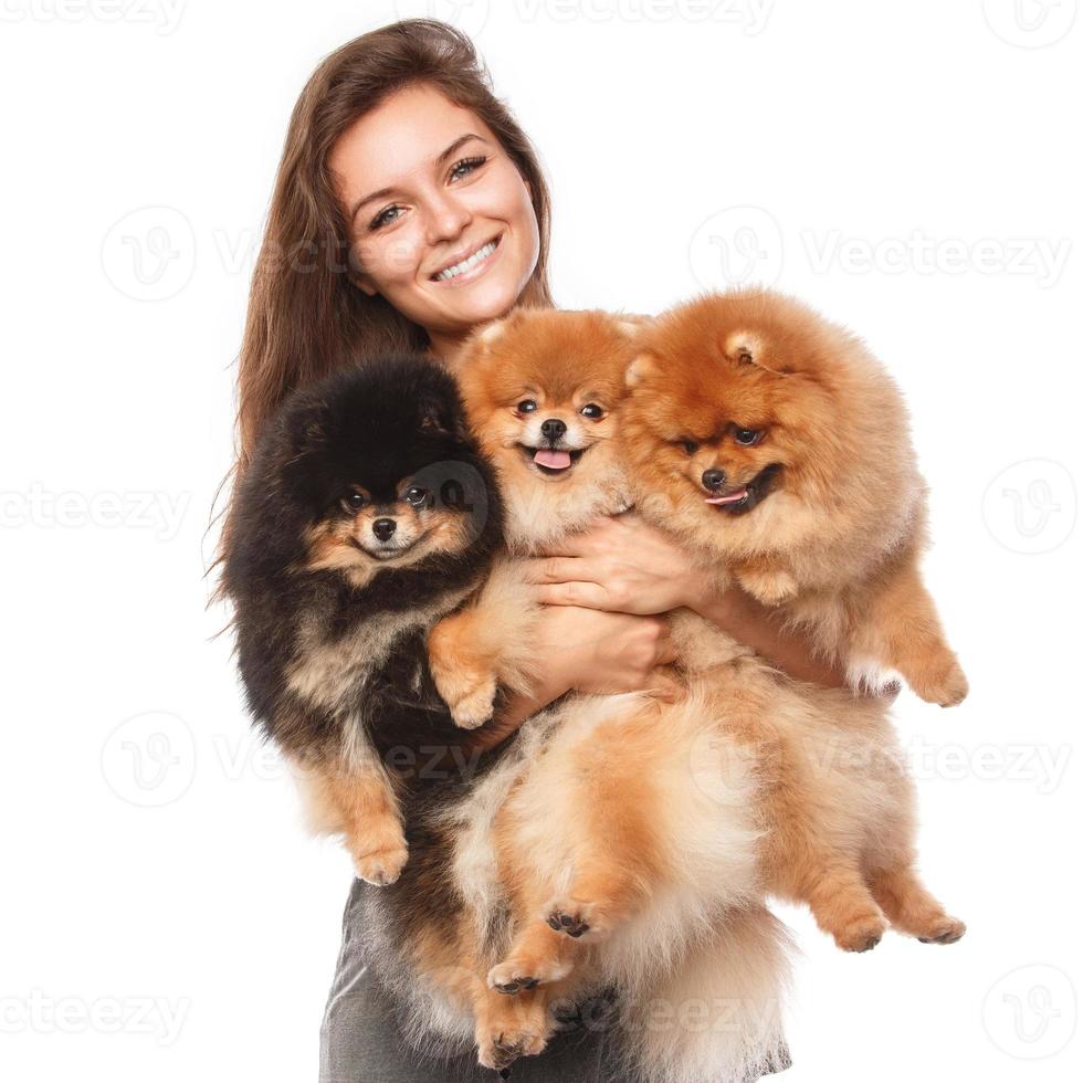 Young woman and cute spitz dogs photo