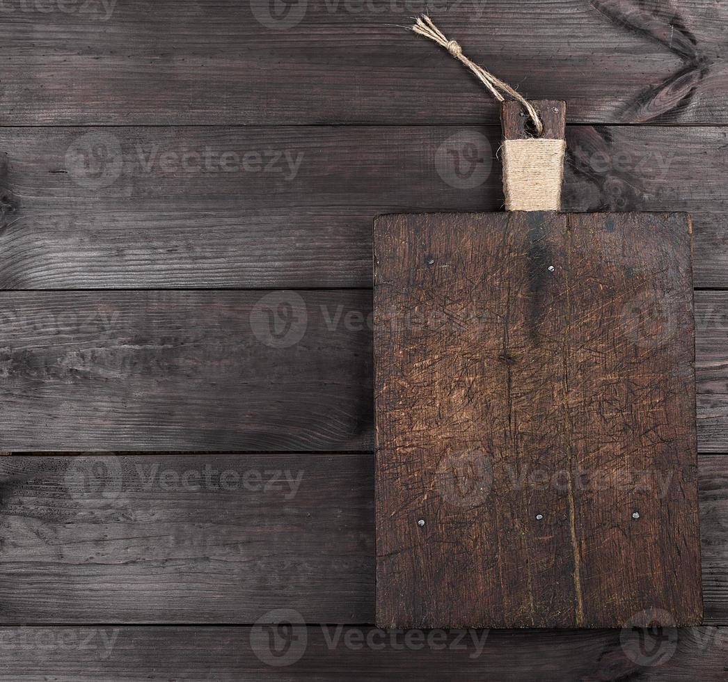 very old brown square cutting board with a handle photo