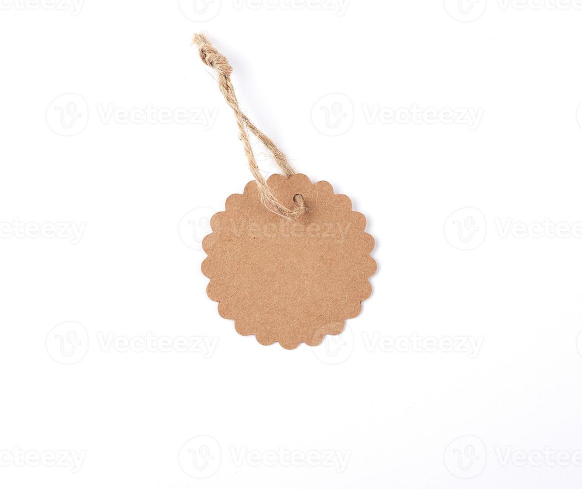 empty paper round brown tag on a rope, white background photo