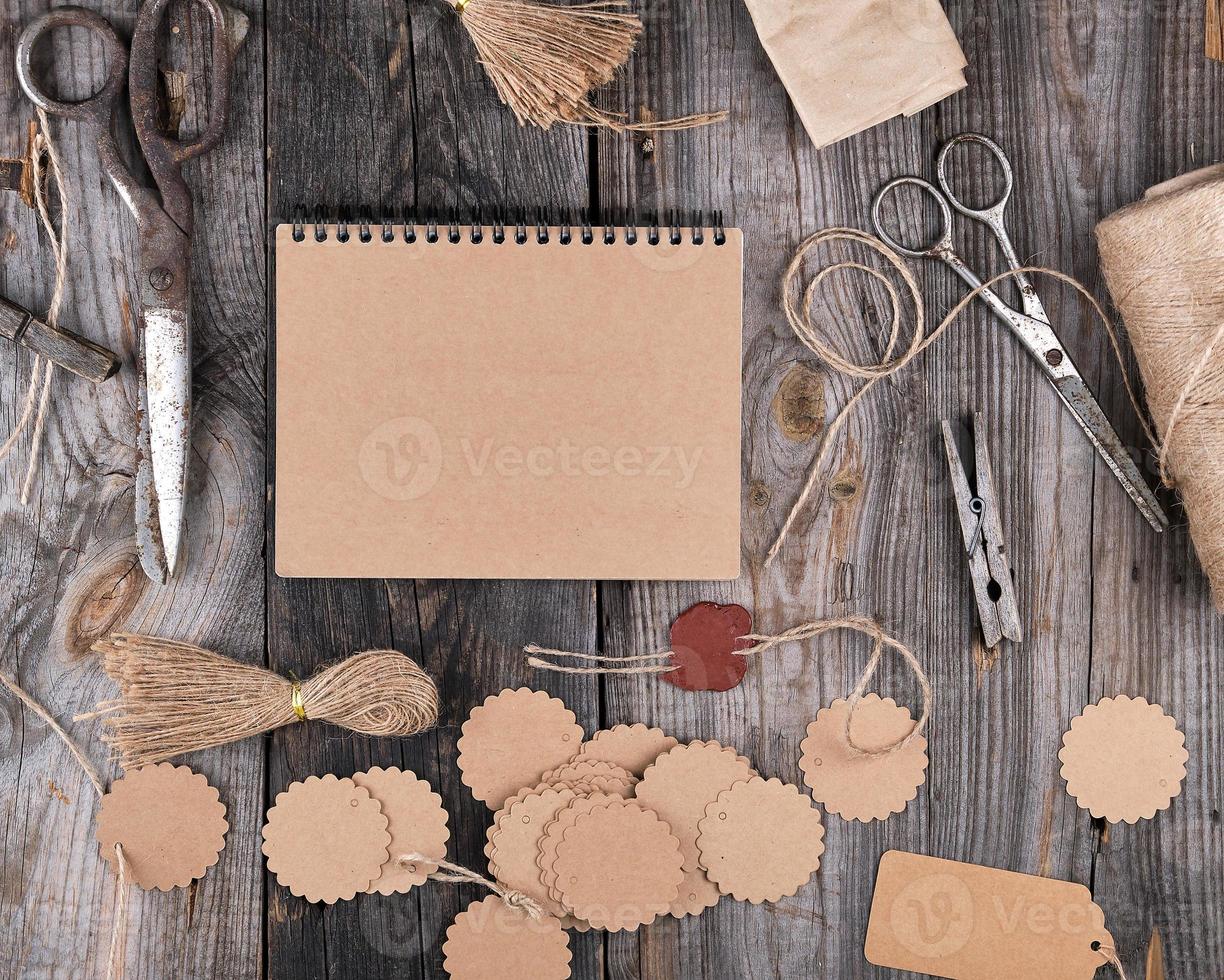 open notepad with brown empty sheets on a gray wooden table photo