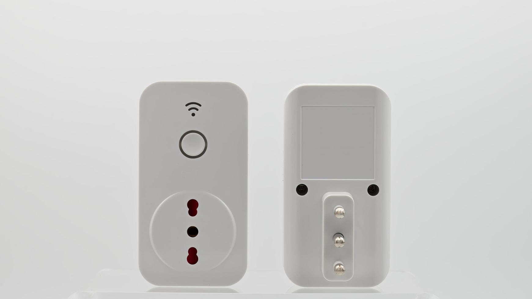Smart wi-fi plug with energy monitor isolated on white background. photo