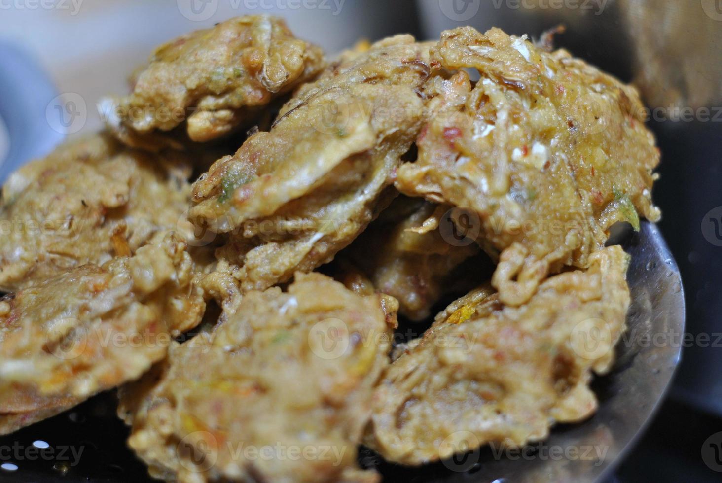 Bakwan is typical traditional snacks of Asian Indonesian people. The ingredients are vegetables, usually, shredded cabbages and carrots, battered and deep fried in cooking oil. photo