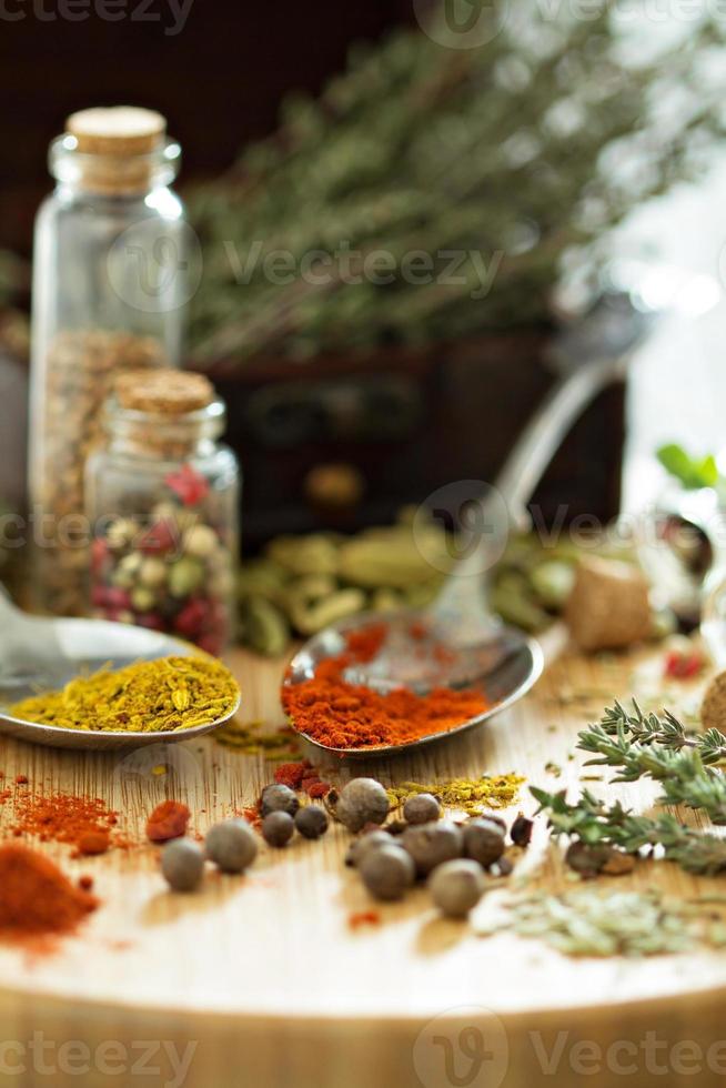 Variety of spices and herb on a wooden board photo