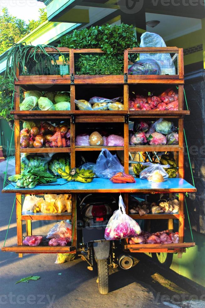 Klaten Indonesia. may 20th 2019. Peddler, selling vegetables using traditional carts on road in morning photo