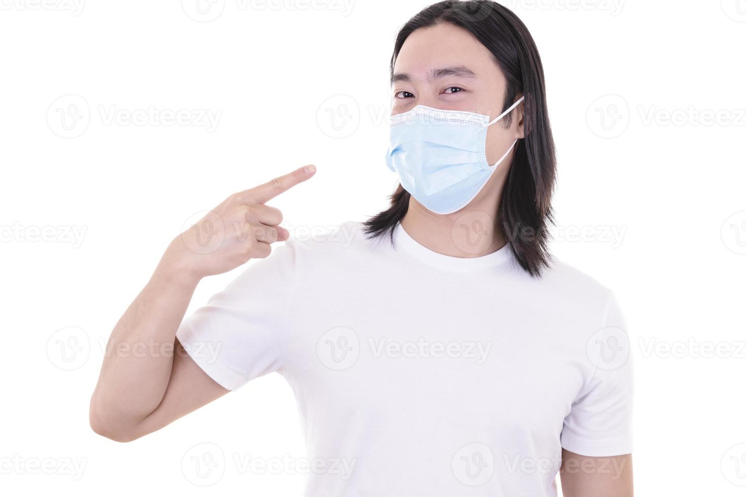 Asian male model wearing and holding surgical face mask and protective gloves photo