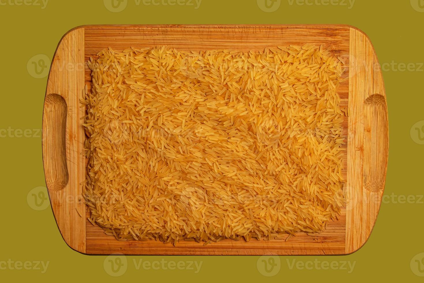 Background of long grain parboiled uncooked rice. Rice groats as background and texture. photo