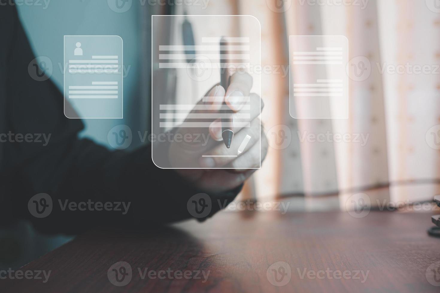 Electronic signature and paperless office concept. A businessman uses a pen to sign electronic documents on digital documents on a virtual screen. photo