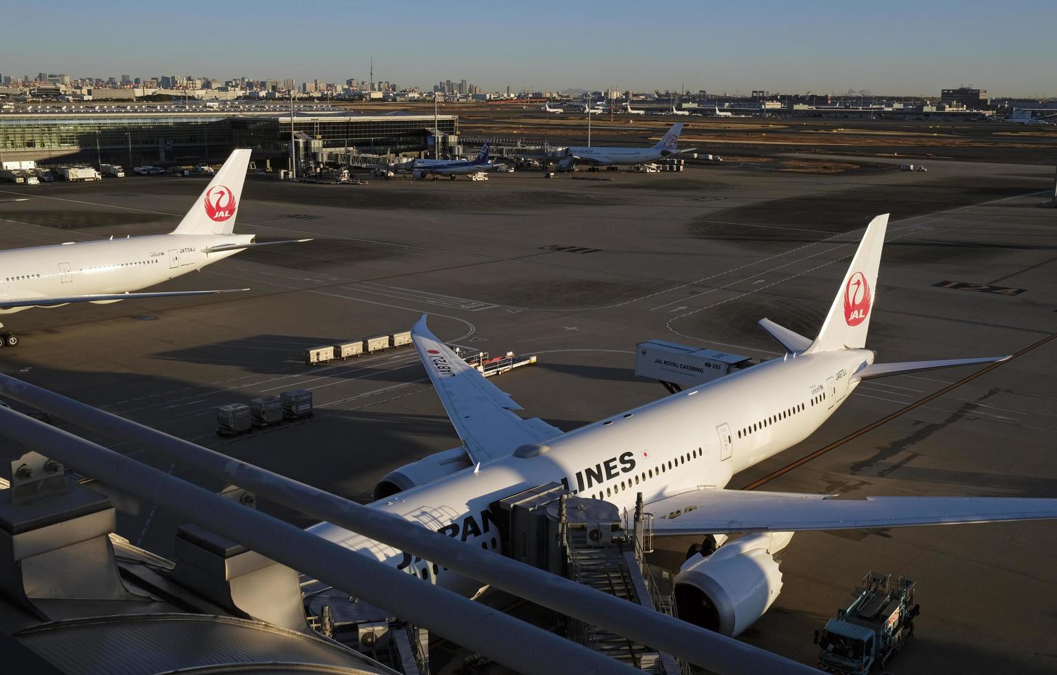 Tokyo, Japan - January 5, 2023 - Planes of Japan Airlines waiting for departure at Haneda airport in Tokyo, Japan. photo