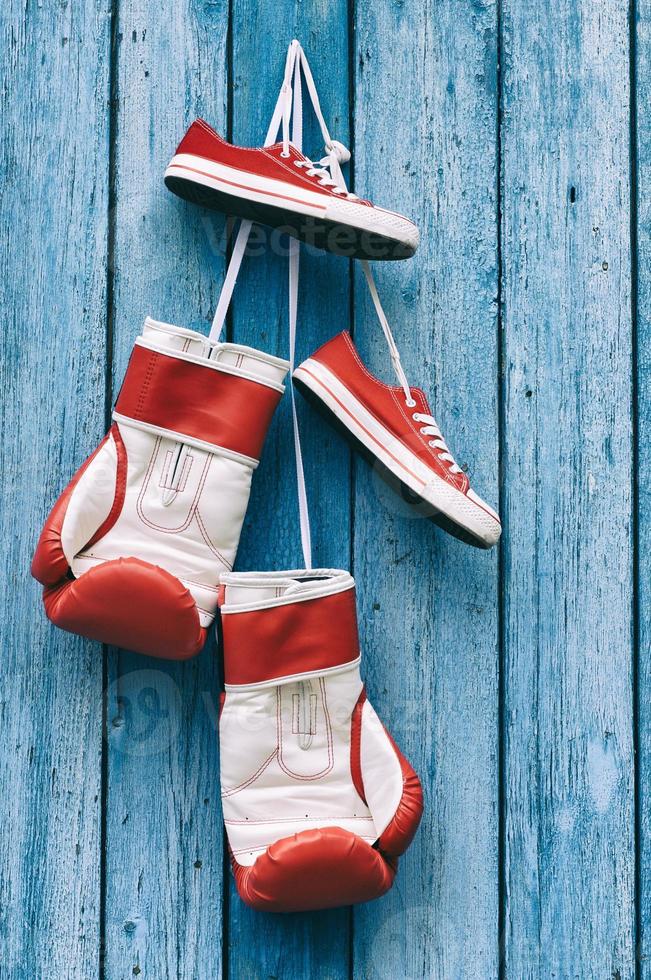 Boxing gloves and shoes hanging on the wall photo