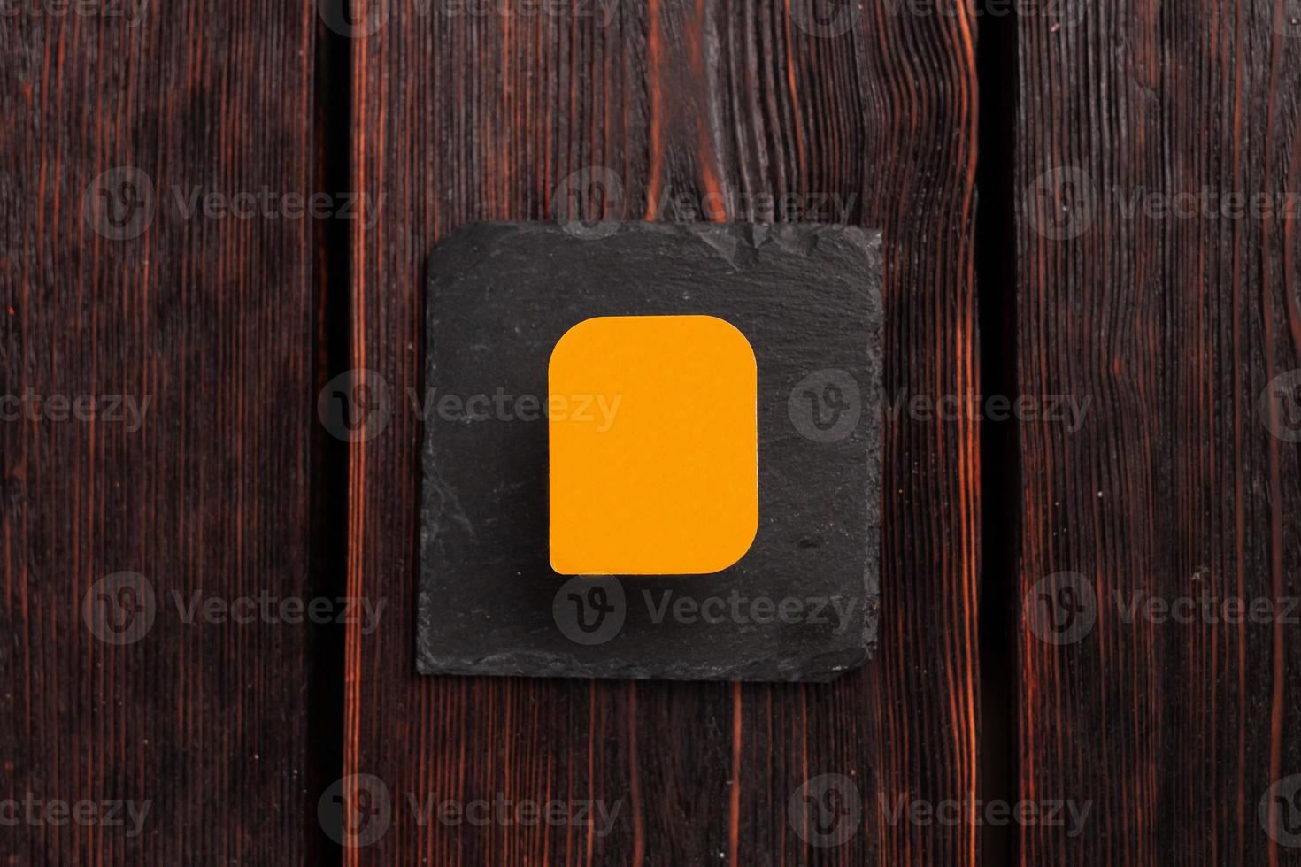 Small plastic box container for sauce on wooden background top view mockup with copy space and place for advertising photo
