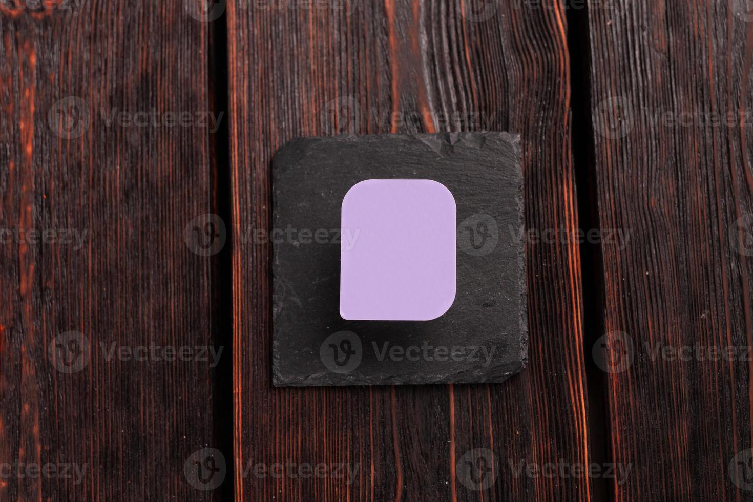 Small plastic box container for sauce on wooden background top view mockup with copy space and place for advertising photo