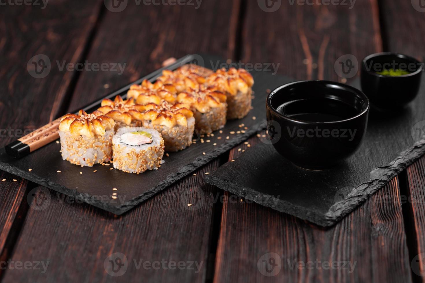Sushi roll philadelphia with crab avocado and cream cheese on black background close-up. Sushi menu. Japanese food concept photo