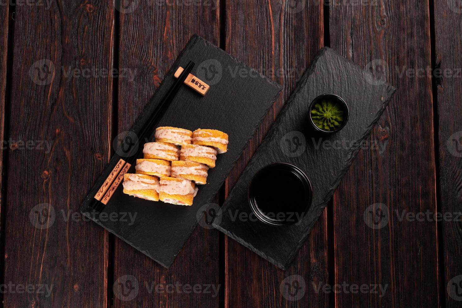 Roll with fish sushi with chopsticks top view - asian japanese food concept photo