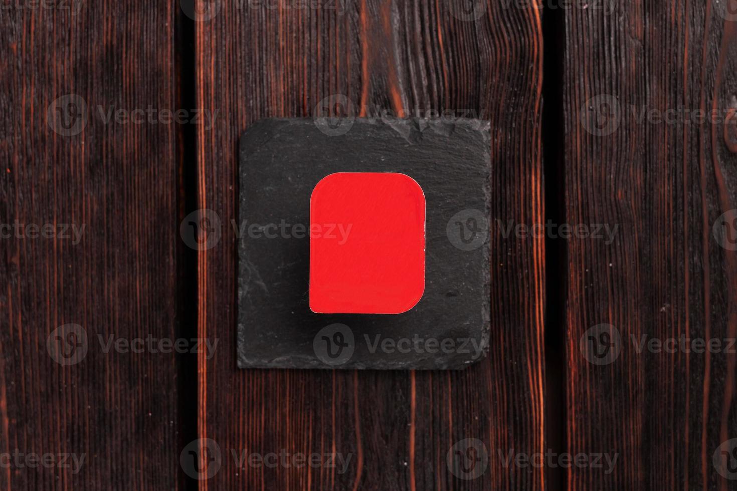 Small plastic box container for sauce on wooden background top view mockup with copy space and place for advertising photo