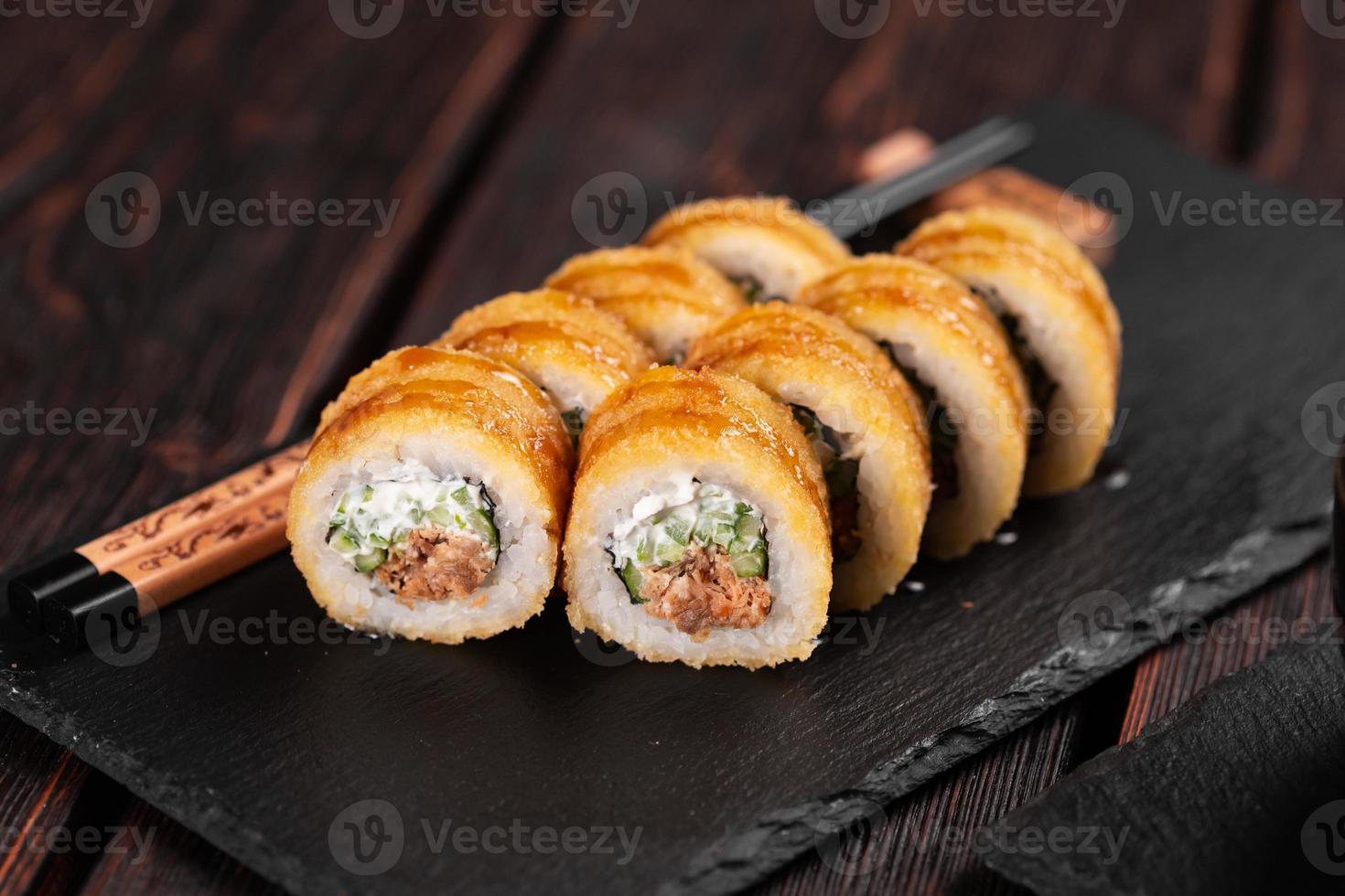 Sushi roll with smoked tuna with cucumber and cheese close-up. Traditional delicious fresh sushi roll set. Sushi menu. Japanese cuisine restaurant. Asian food photo