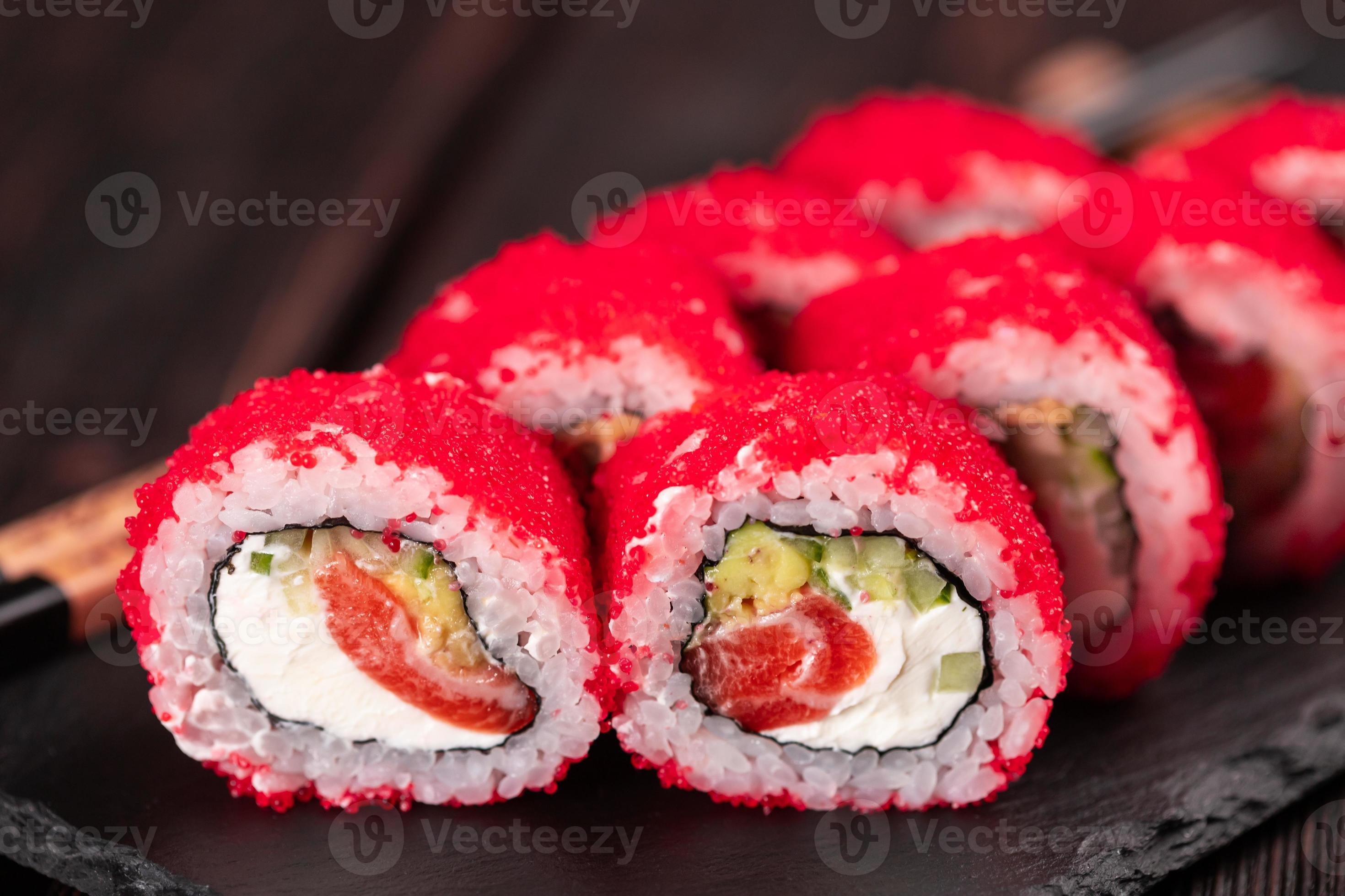Japanese sushi roll set with red flying fish caviar. Pickled