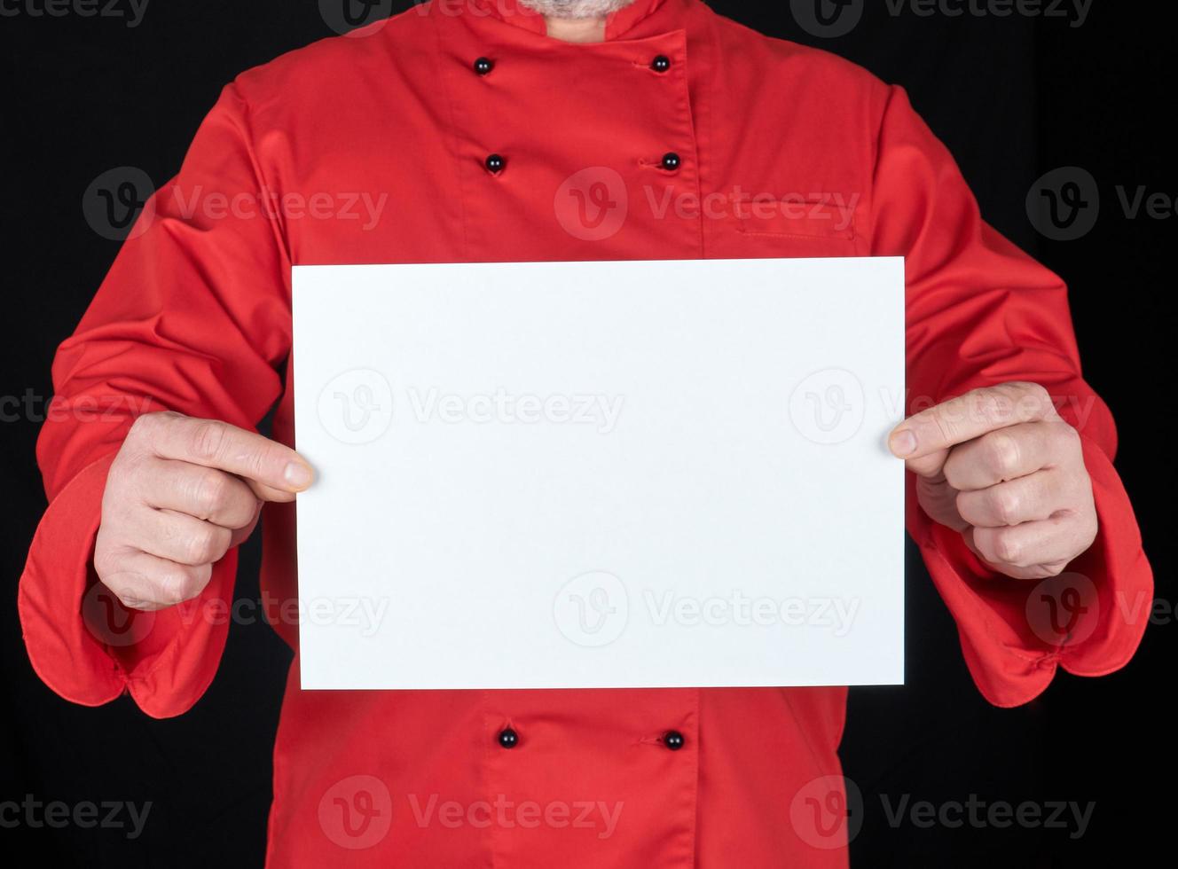 chef in red uniform holding a blank white paper sheet photo