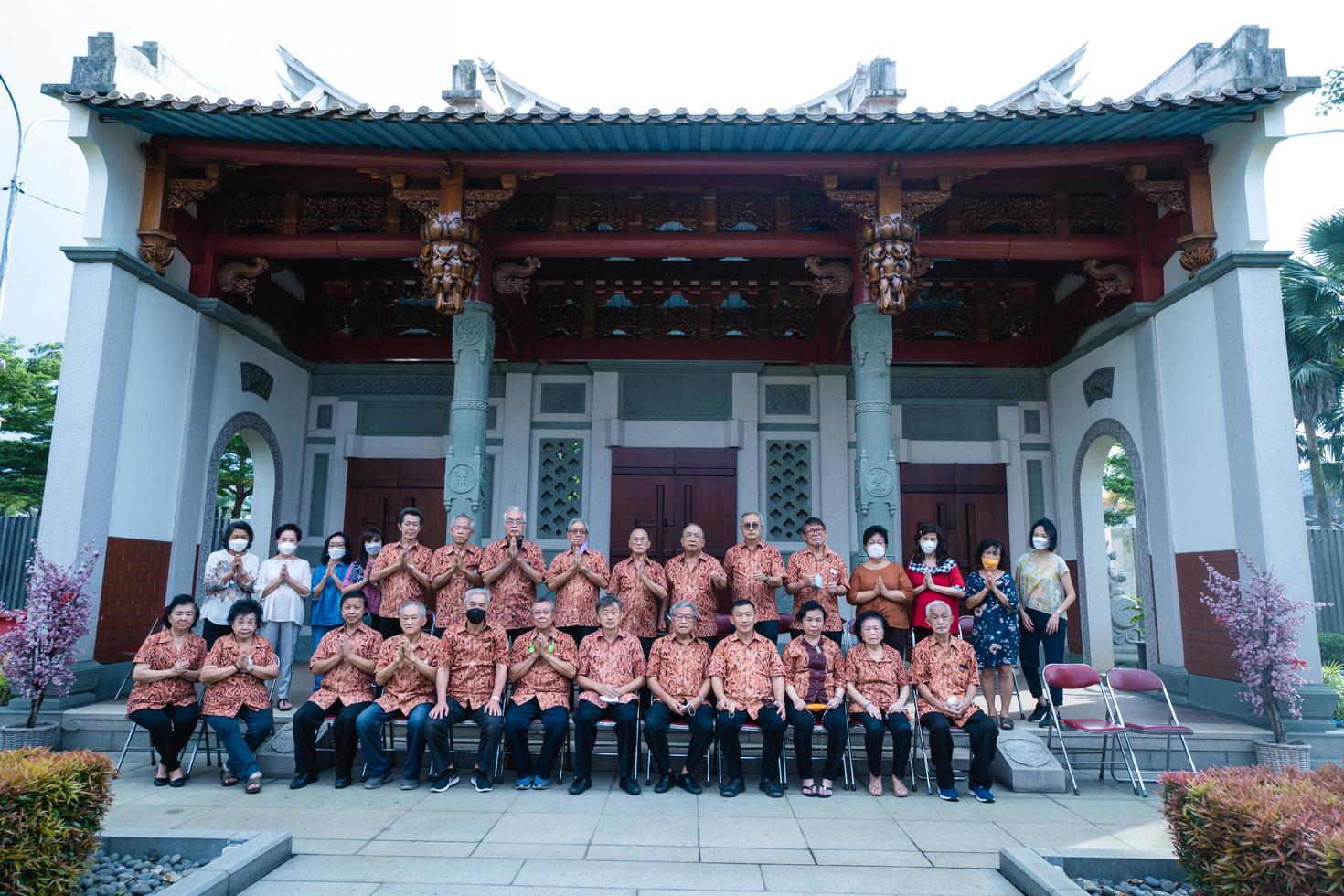 Bandung City, Indonesia, 2022 - The monks sitting together for taking a photo in front of the Chinese gate