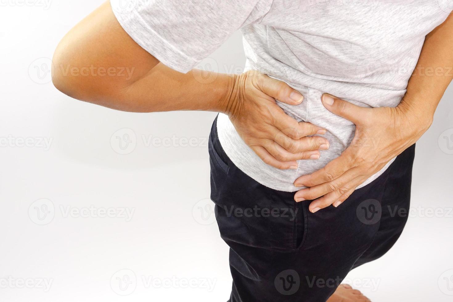 Woman suffering from waist or hip pain on white background. Chronic gastritis, office syndrome and health concept. photo