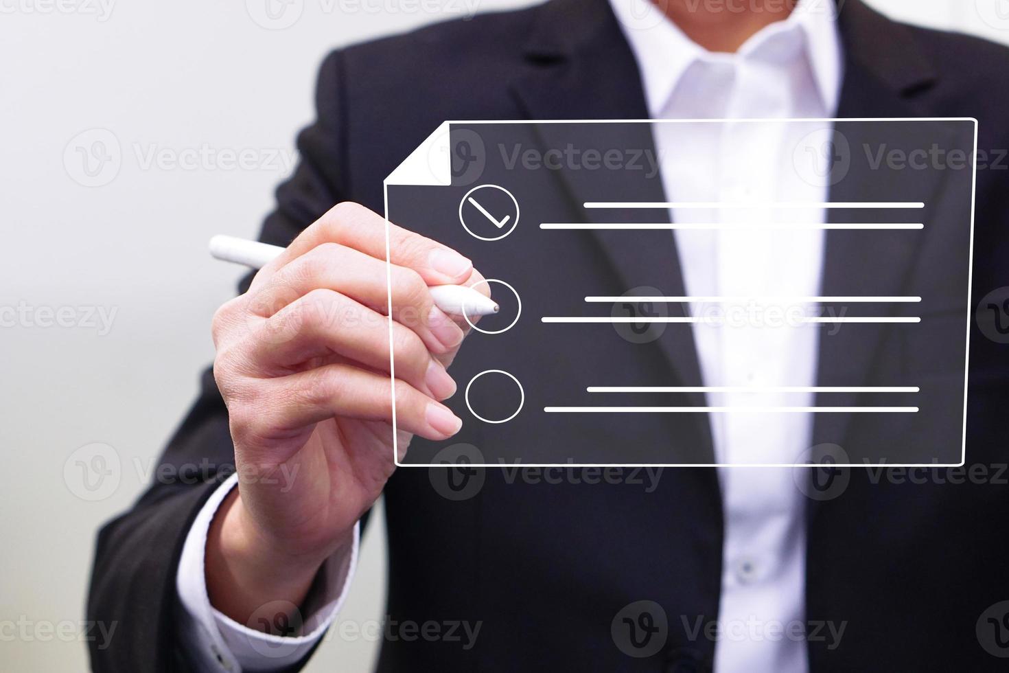 Businessman working on a digital document on a virtual screen using a stylus pen. Concept of Technology and future document management. photo