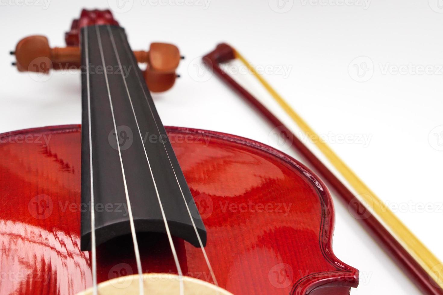 Close up of violin neck against on white background with copy space. Instrument and musical concept. photo