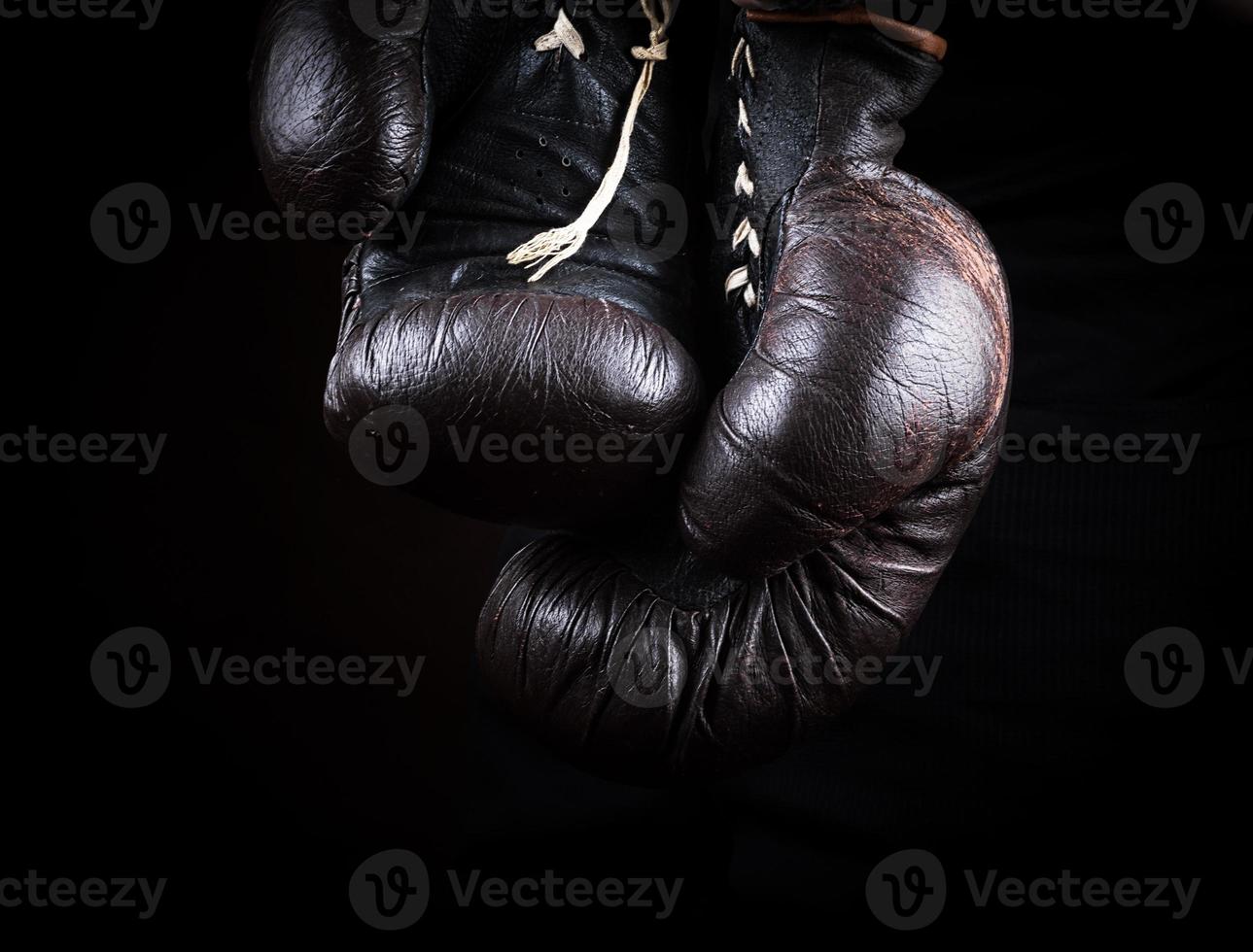 pair of very old brown boxing gloves hanging photo