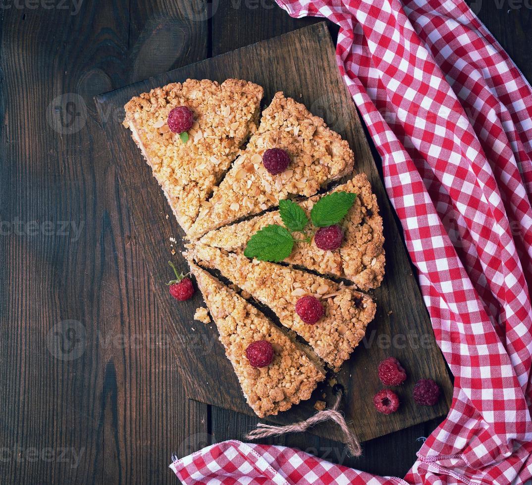 sliced triangular pieces of crumble pie with apples photo