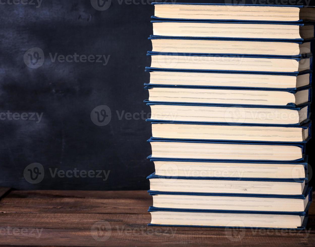 large stack of books in a blue cover photo