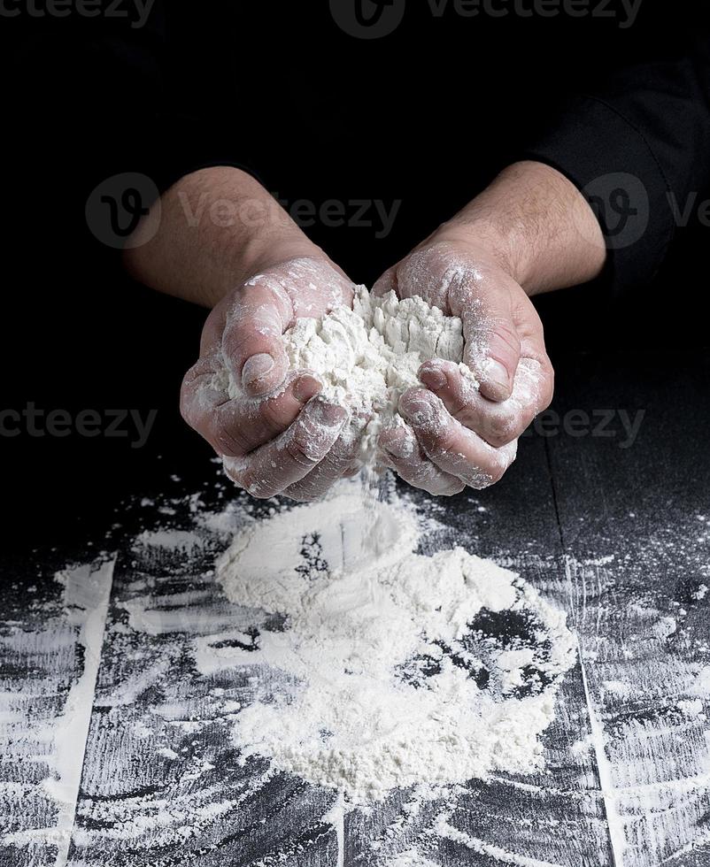 white wheat flour in male hands photo