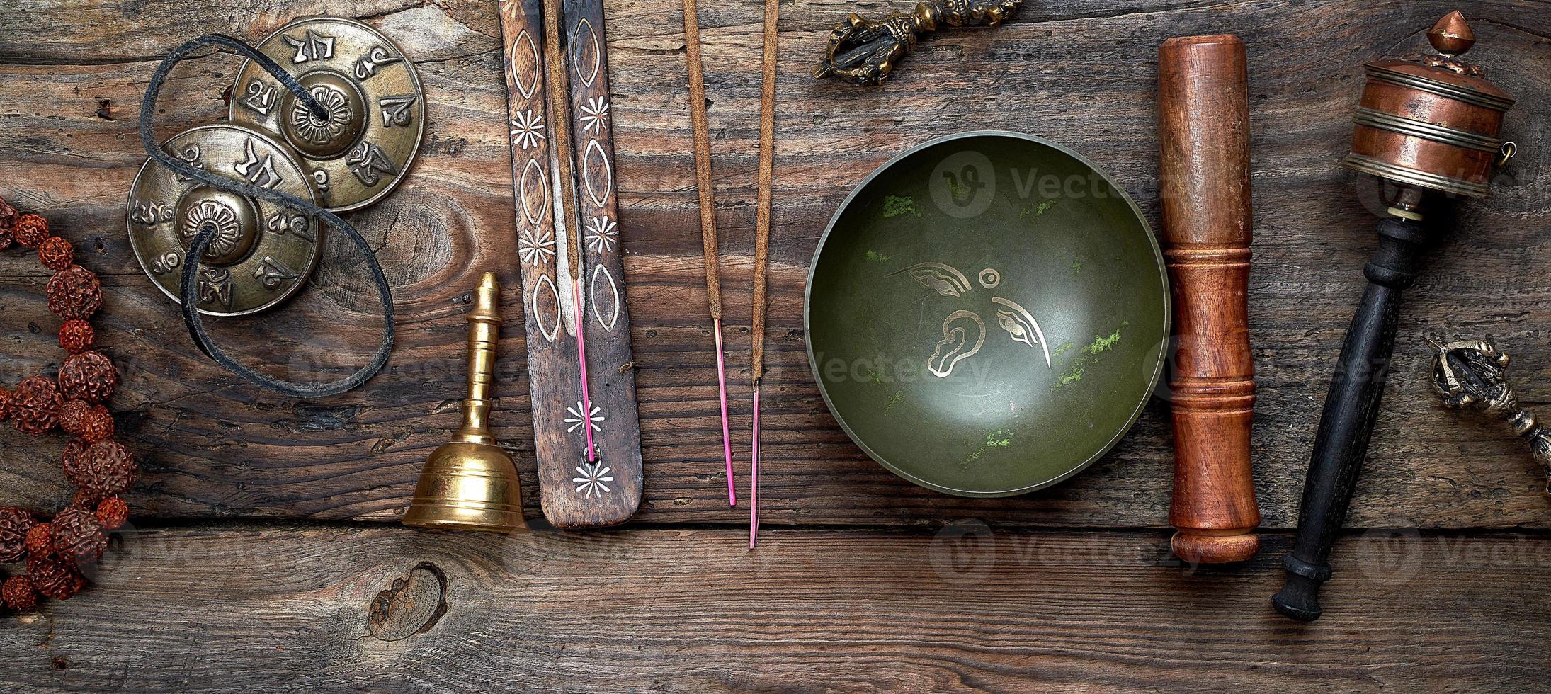 Tibetan singing bowl and other religious ritual instruments for meditation photo