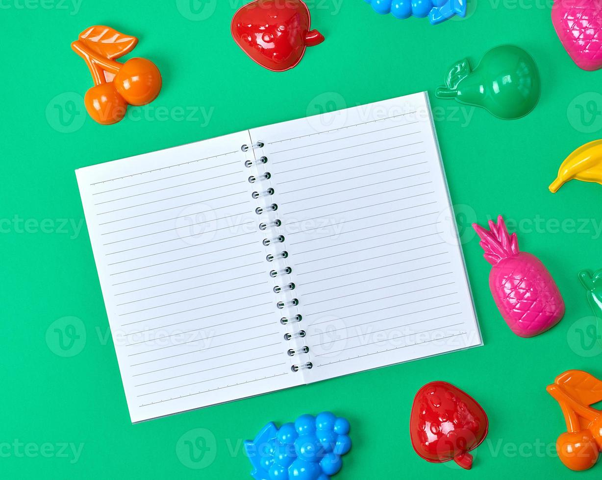 open notebook in line on a green background photo