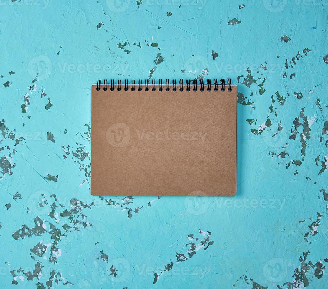 notebook on a black iron spring with brown empty sheets photo