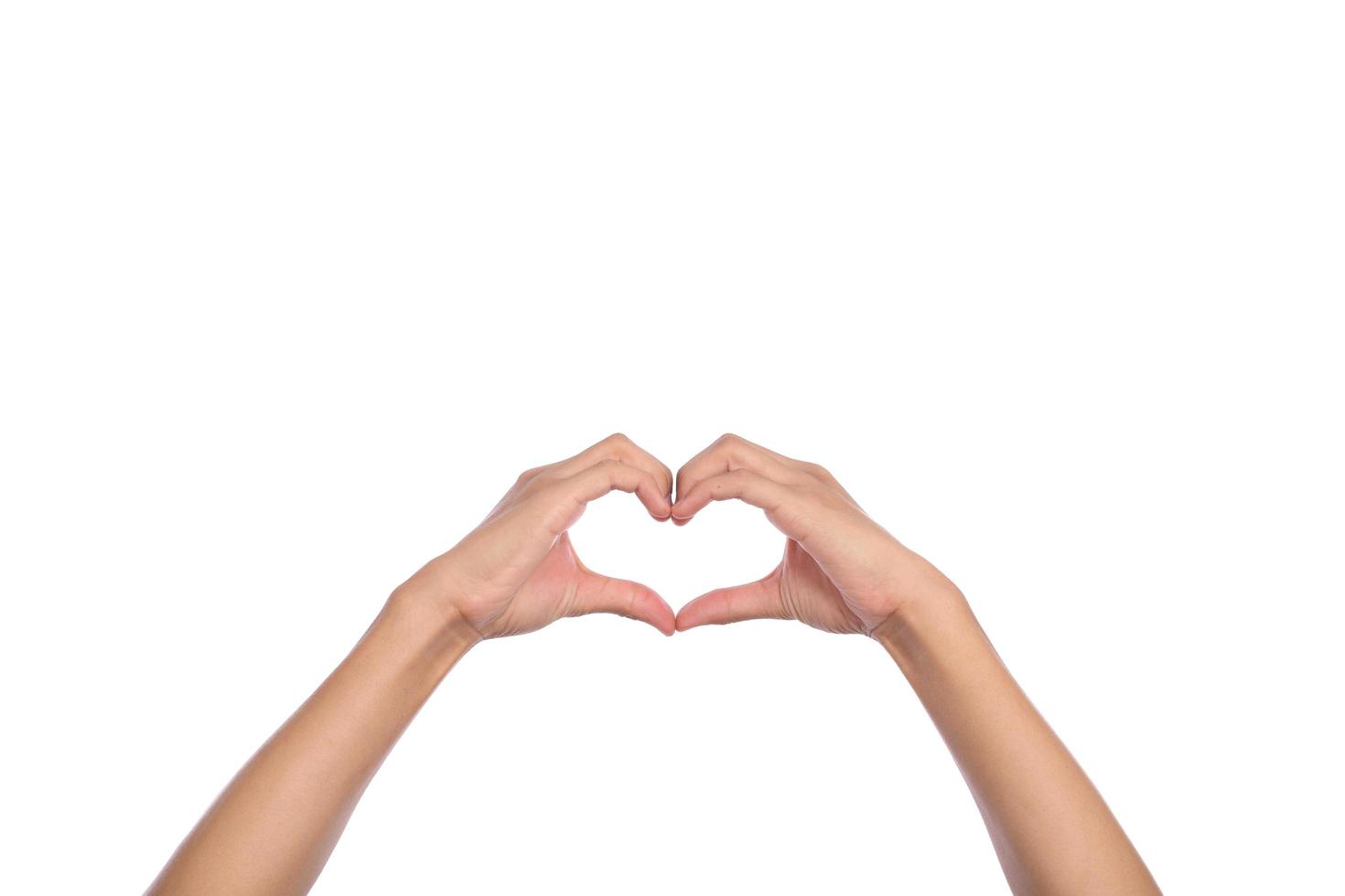 Woman hands making a heart shape on a white isolated background photo