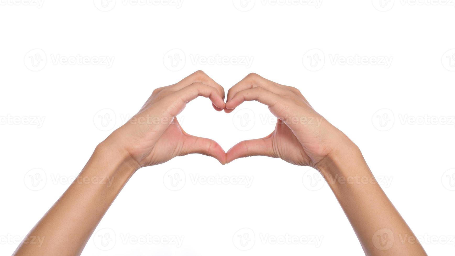 Woman hands making a heart shape on a white isolated background photo