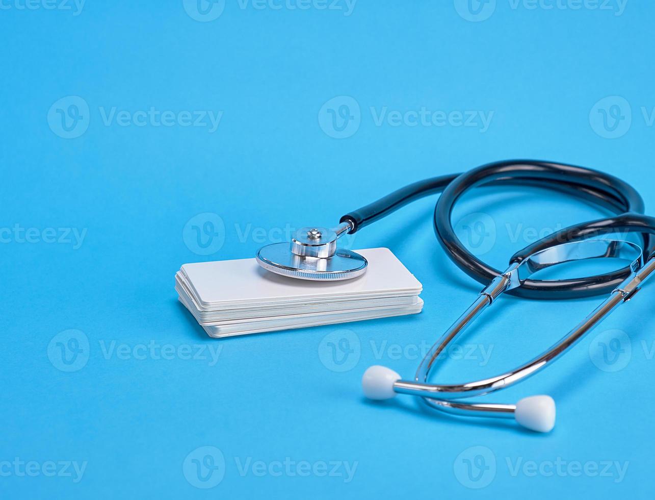 medical stethoscope and empty paper business cards photo