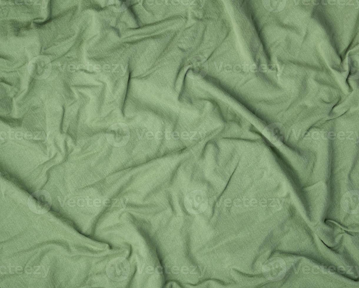 green crumpled soft fabric, full frame photo