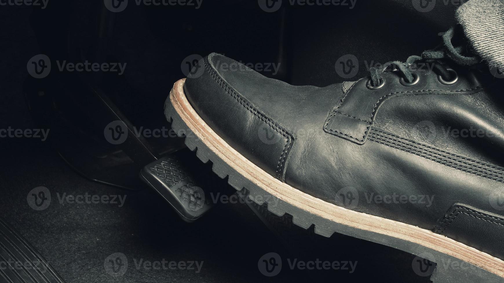 Close up foot press or push foot break and accelerate pedal of a car to drive ahead. photo