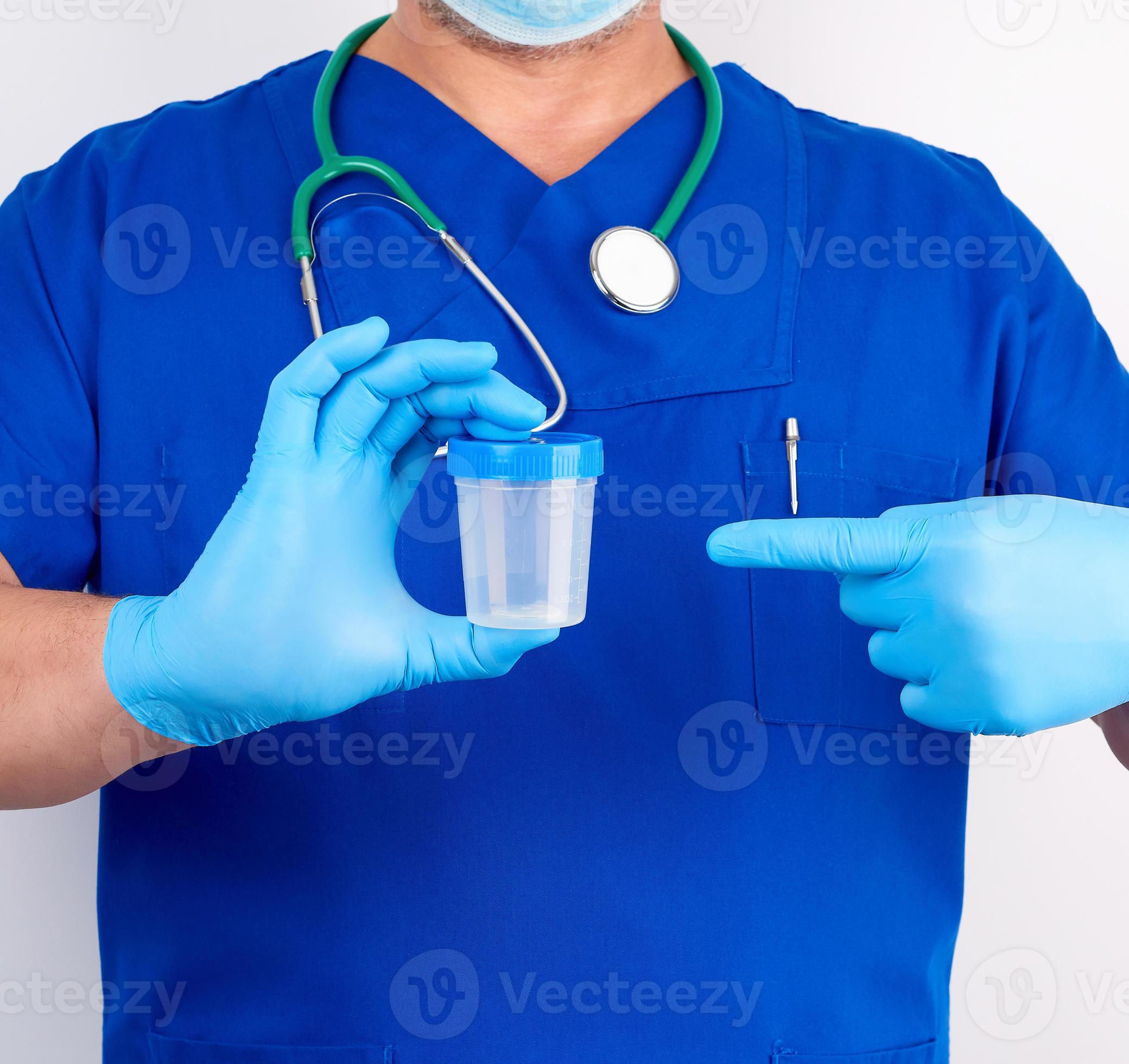 doctor in blue uniform and latex gloves is holding an empty plastic