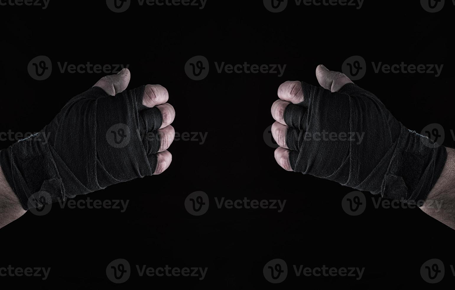 two mens hand wrapped in black sports textile bandage photo