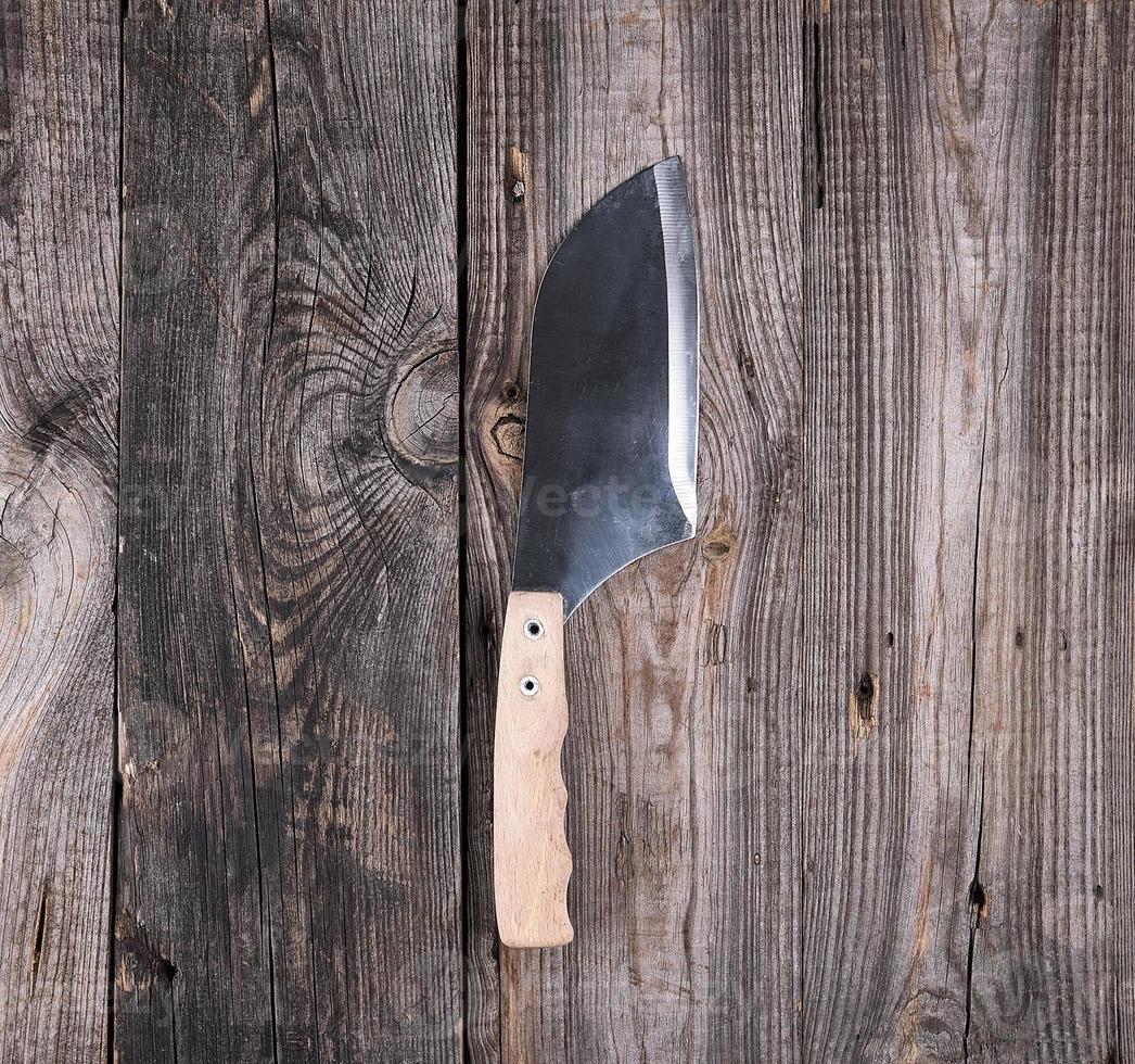 steel knife for cutting meat with a wooden handle photo