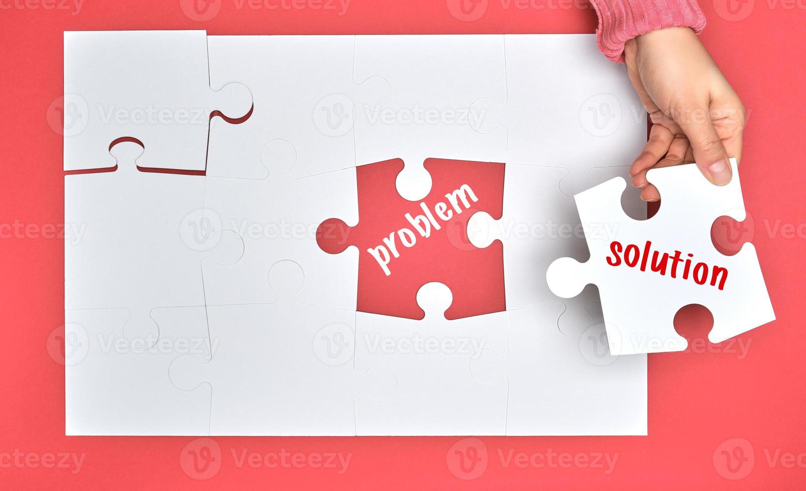 female hand holding white puzzle with the word solution, process of closing the missing element with the word problem photo