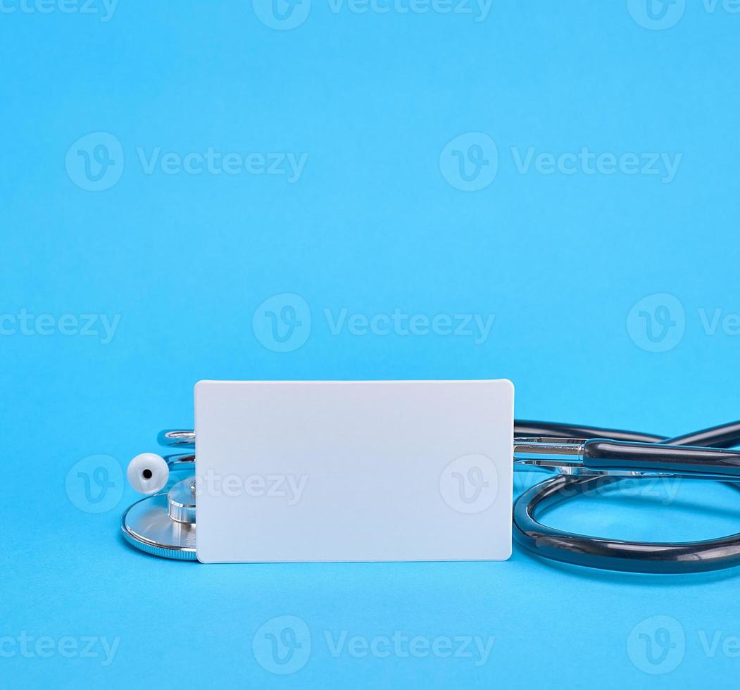 medical stethoscope and empty paper business card photo