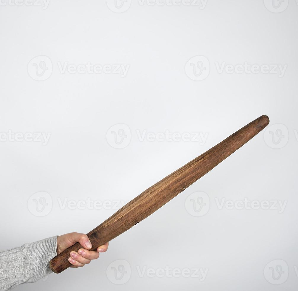 hand holding a wooden rolling pin photo