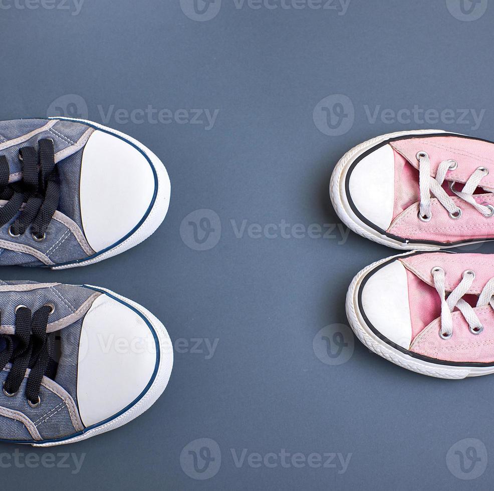 textile worn sneakers on a black background photo