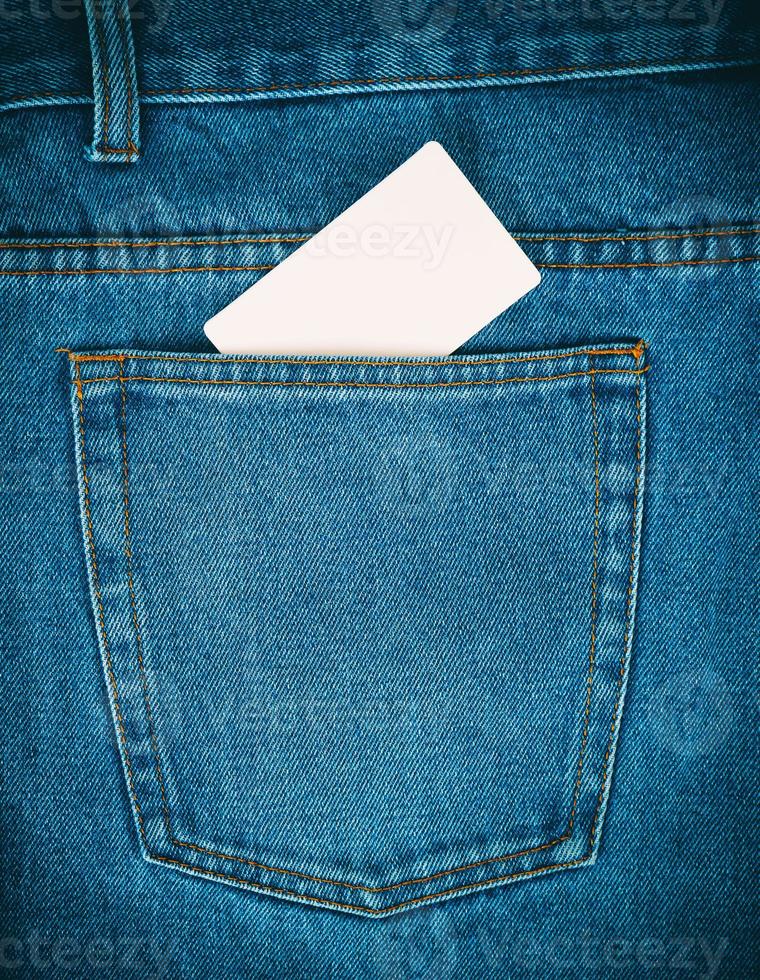 empty paper card is in the back pocket of blue jeans photo